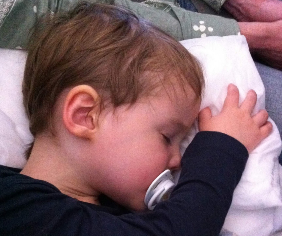 Lukas sleeping on a long flight
