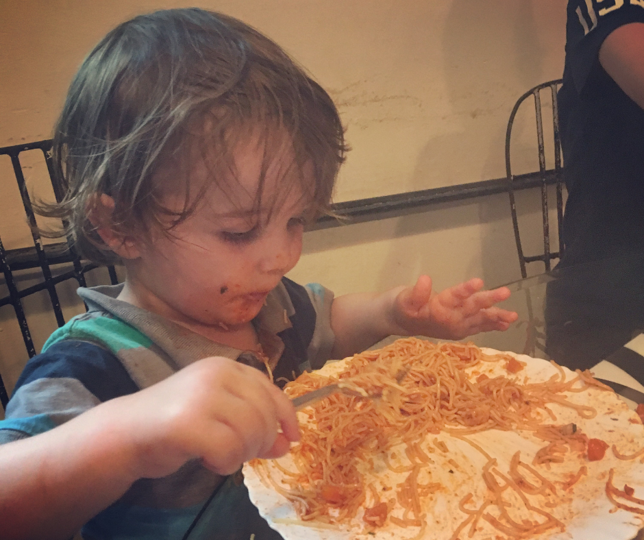 Sawyer eating pasta and being covered in pasta