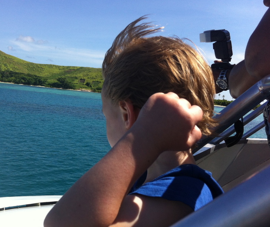 Lukas looking at Mana Island from the front of the boat