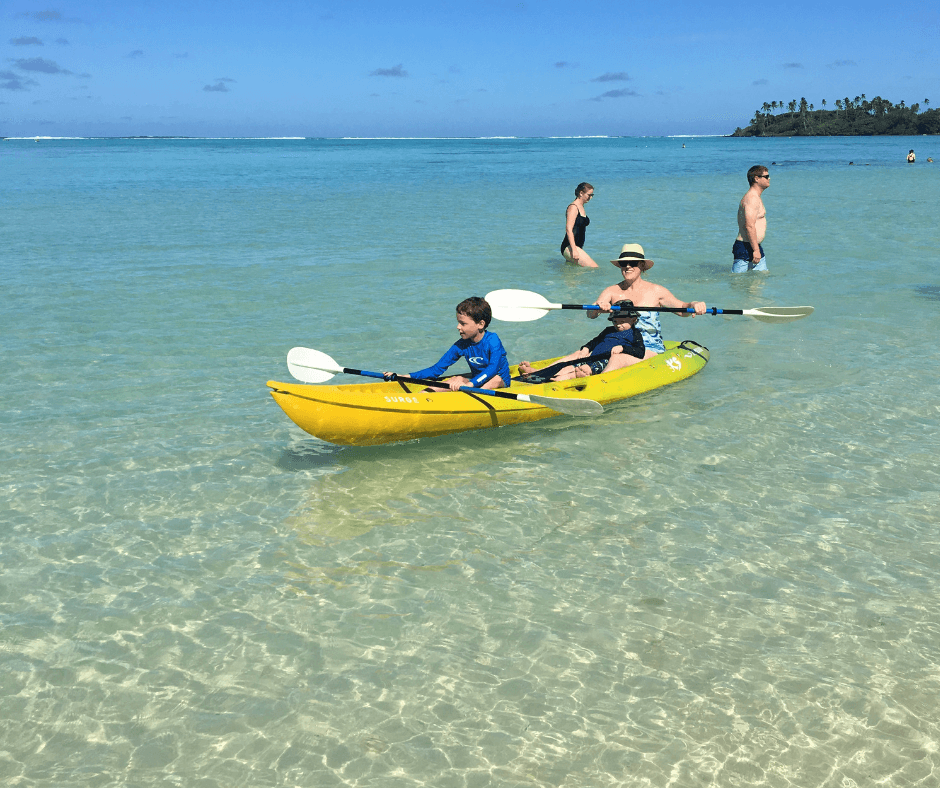 Sammy and the kids kayaking on the waters on Muri lagoon