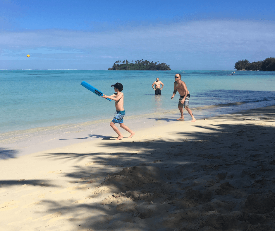 Everyone playing beach cricket on Muri, great family fun Rarotonga