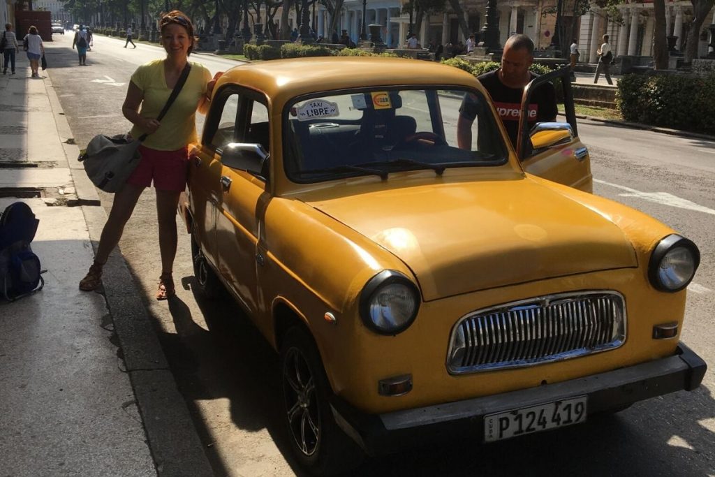 Connie standing beside our 1957 Ford Taxi