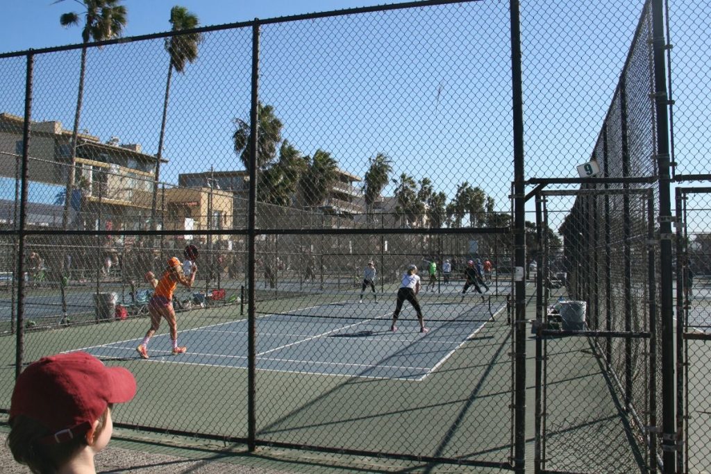 Lukas watching a doubles paddle tennis match