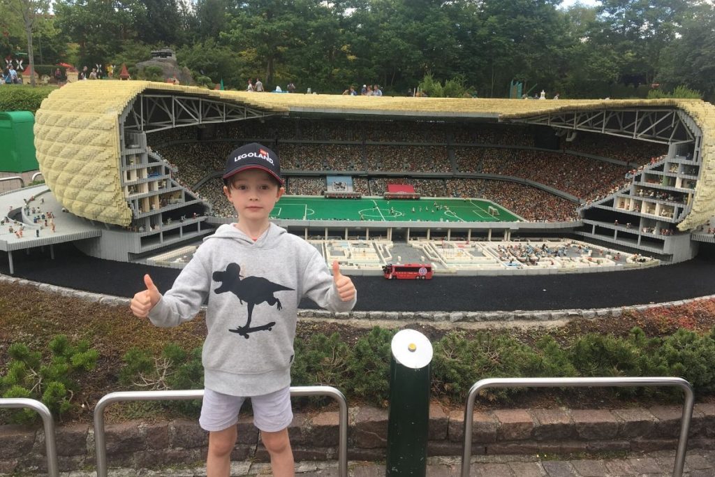 Lukas posing for a photo with the Allianz Arena