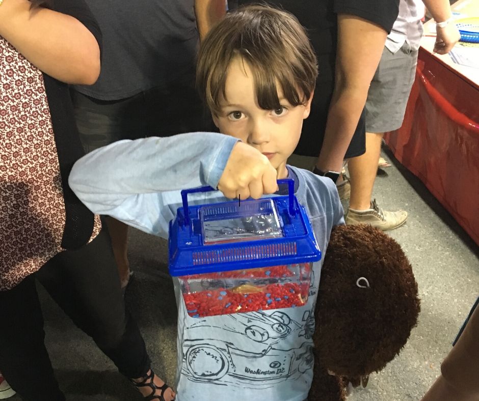 Lukas proudly holding the fish he win at the ring toss.