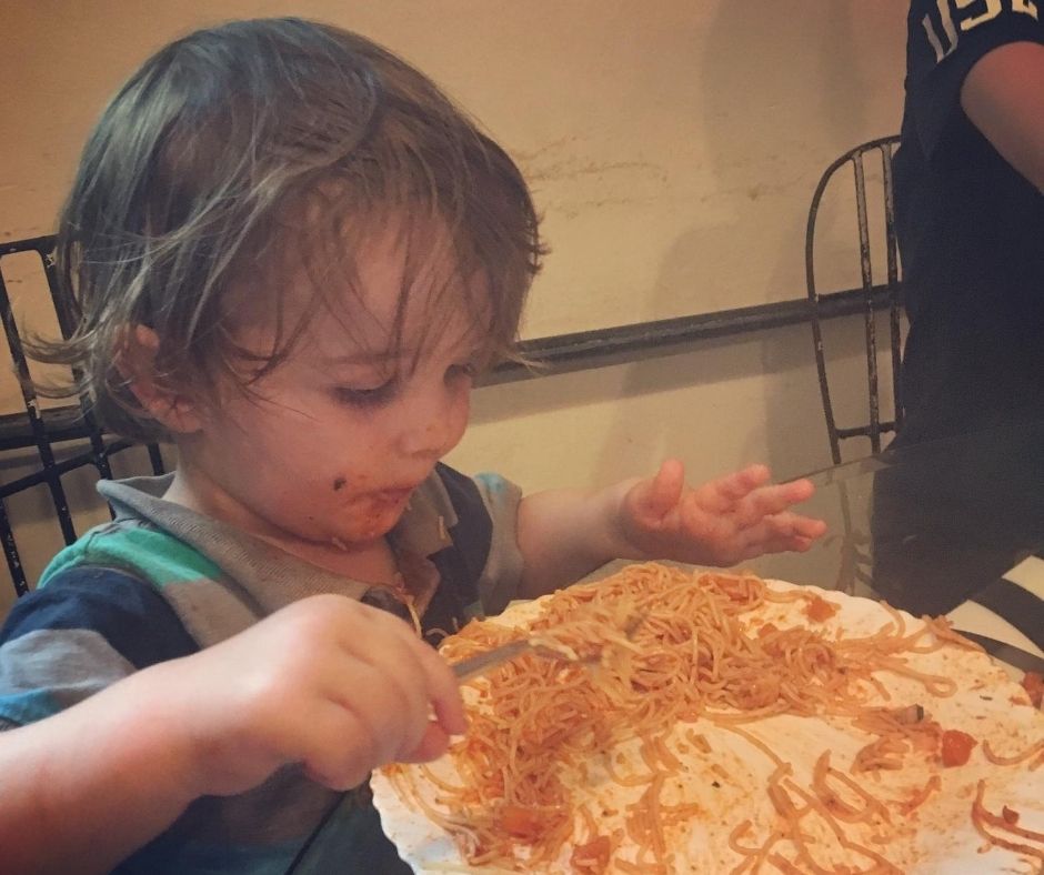 Sawyer eating pasta and being covered in pasta