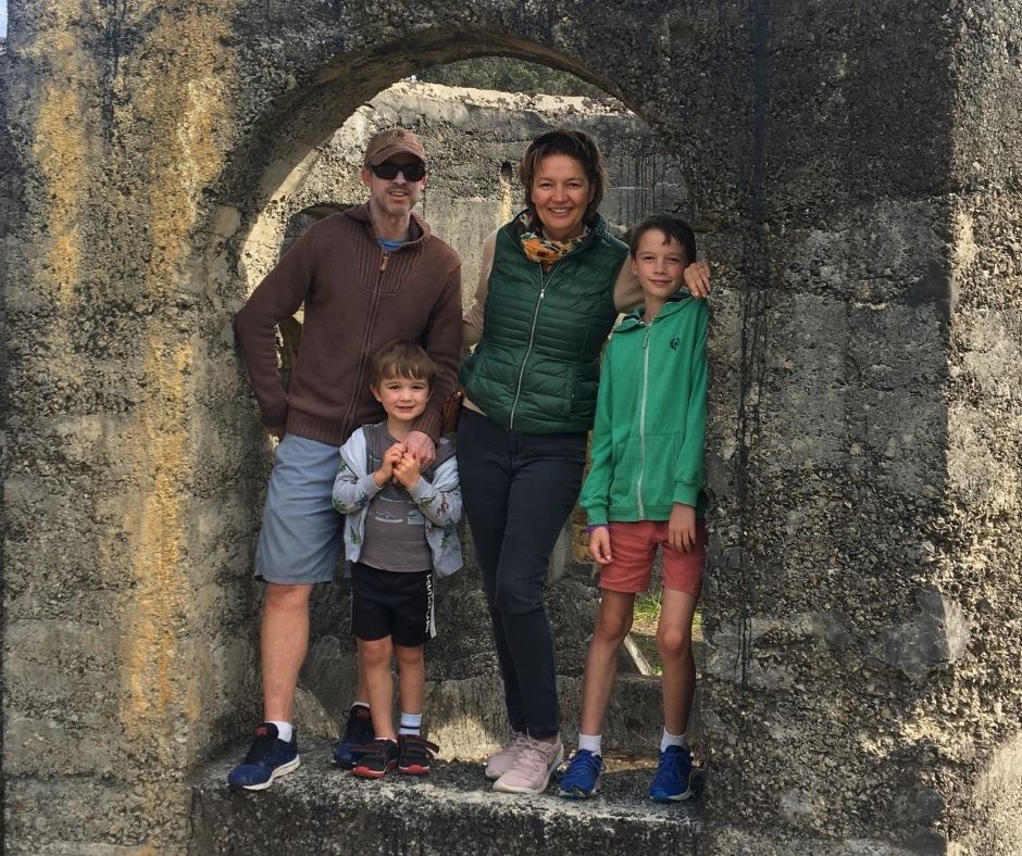 Family posing for a photo in a archway in the ruins of the Victoria Battery