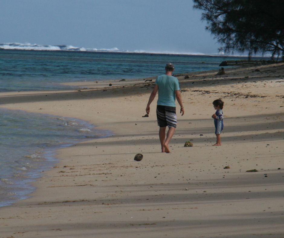 Dad and Sawyer exploring the beach together with the lagoon in the background