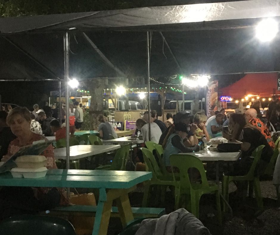 People sitting around and enjoying the food at the Muri Night Markets