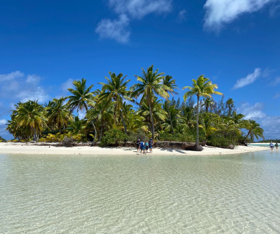 THe island of One Foot, with lush palm trees surrounded by beautiful water