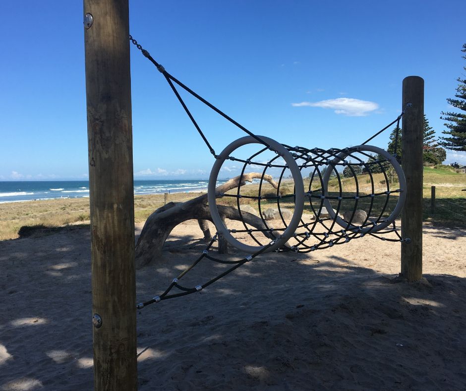 View of the playground and the beach. One of the best things to do at Mount Maunganui with kids