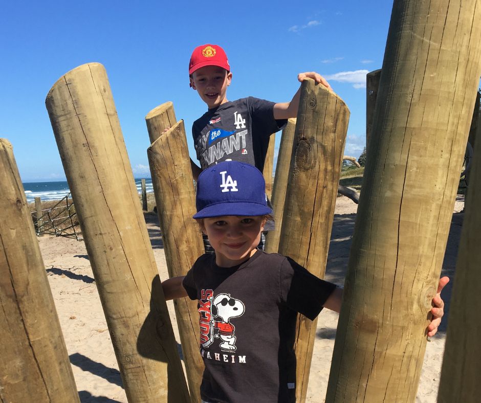 The boys posing for a photo on the obstacle course