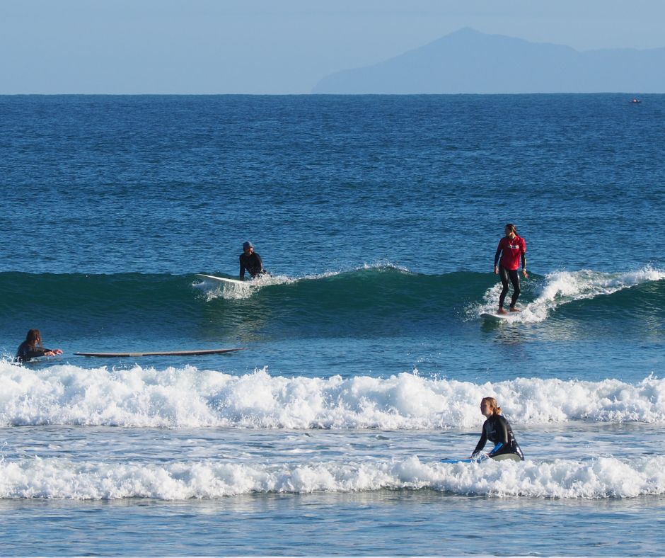 Mount Maunganui Surf Lessons with Hibiscus Surf School, everyone riding the waves