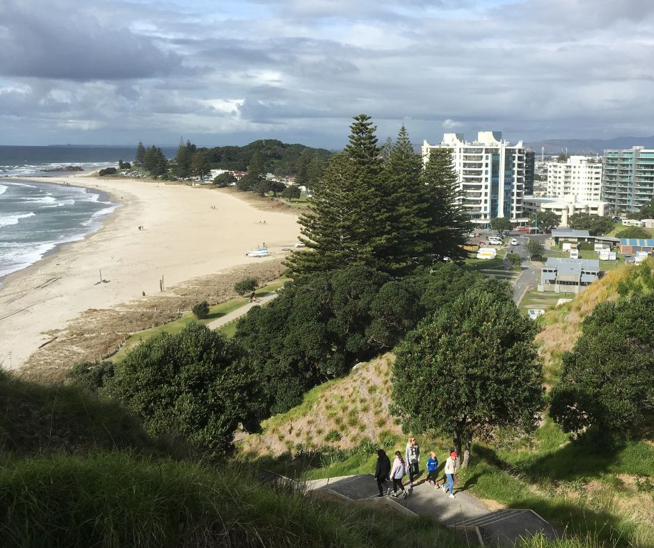 View of the Main beach and the steps as people start their walk up Mauao