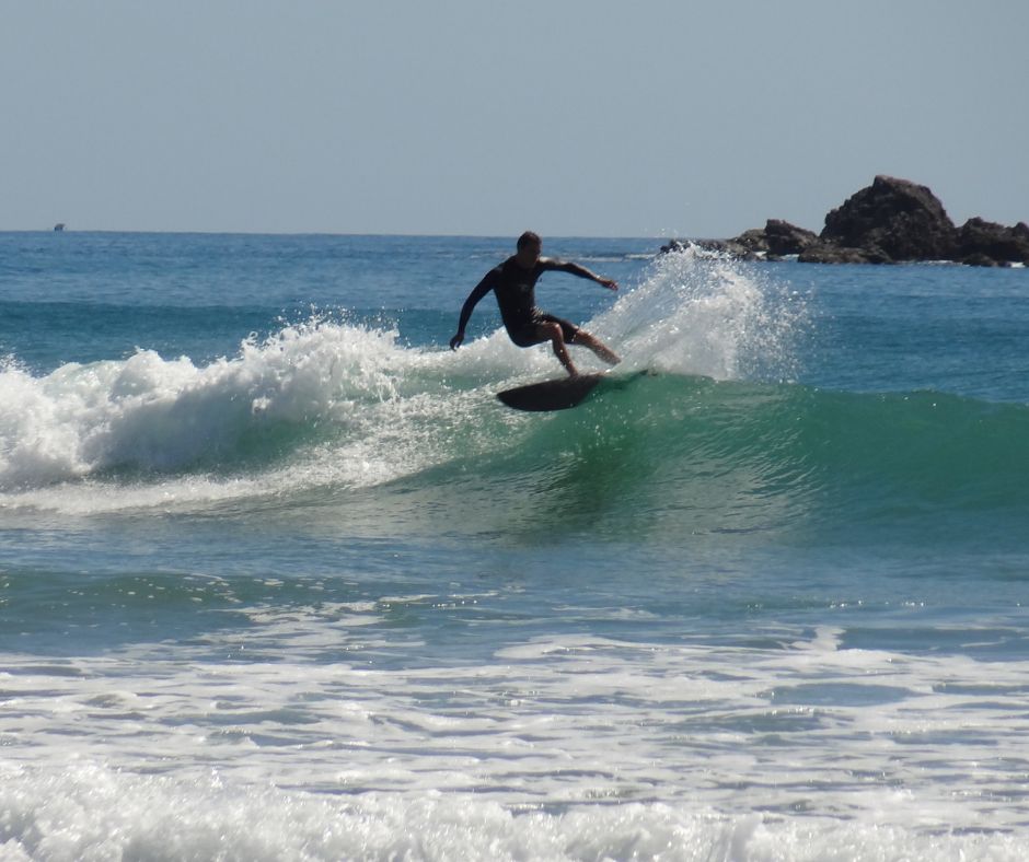 A surfer carving it up on a wave