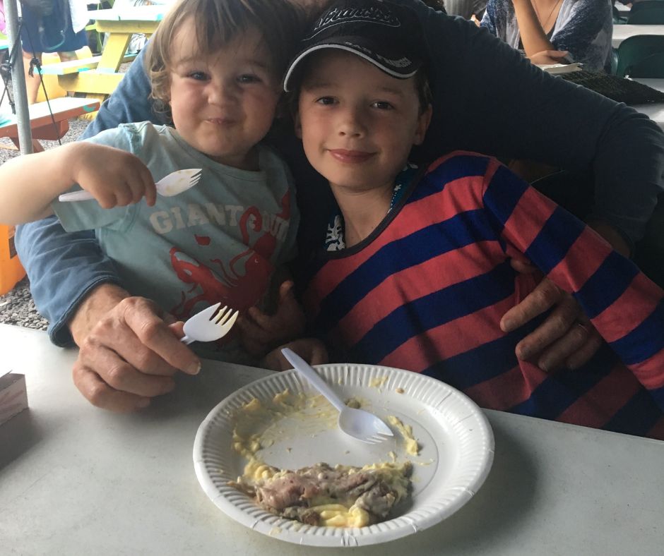 The boys eating Island Crepes (Strawberry and custard) at Muri Night Market