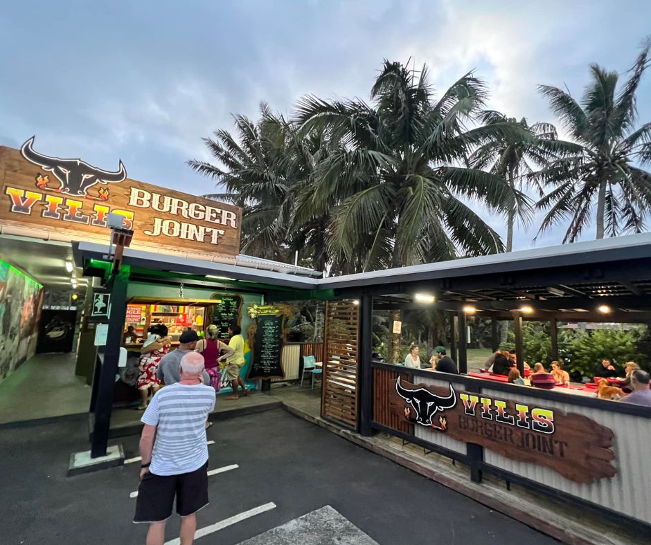 The front of Vili's burger place, people queueing and eating delicious burgers. This is one of Rarotonga's best restaurants and cafes for burgers.