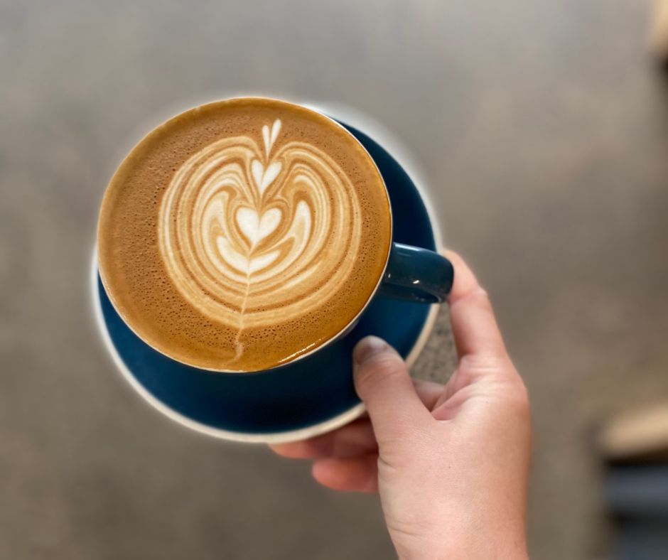 Cup of coffee with form hearts in the centre. One of the best coffees out of all the Papamoa Cafes