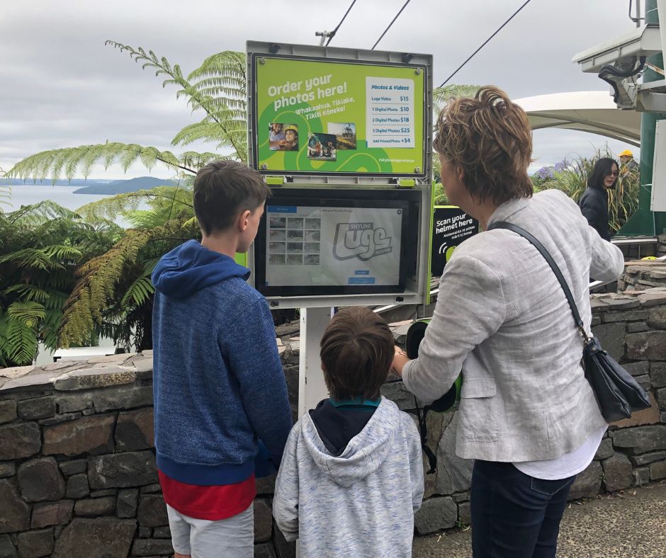 Connie, Lukas ans Sawyer looking at photos and videos of their day out