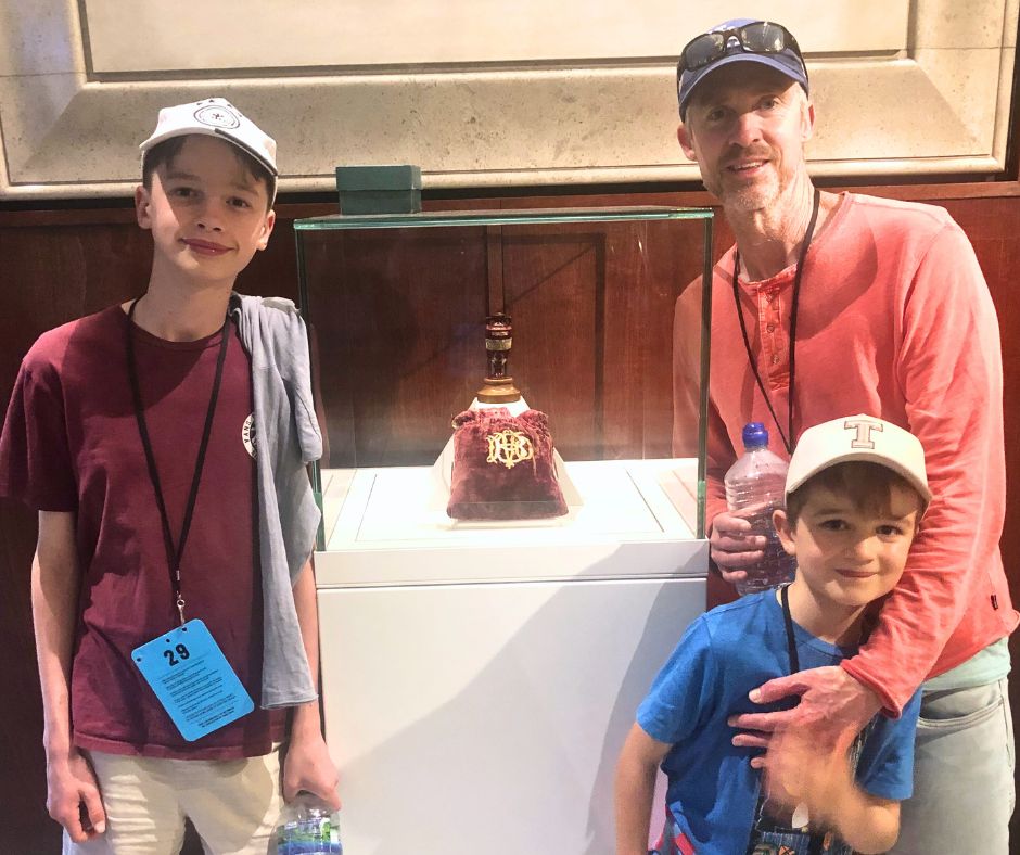 Dad and the boys posing with the famous ashes urn at the start of our Lords Cricket Ground Tour