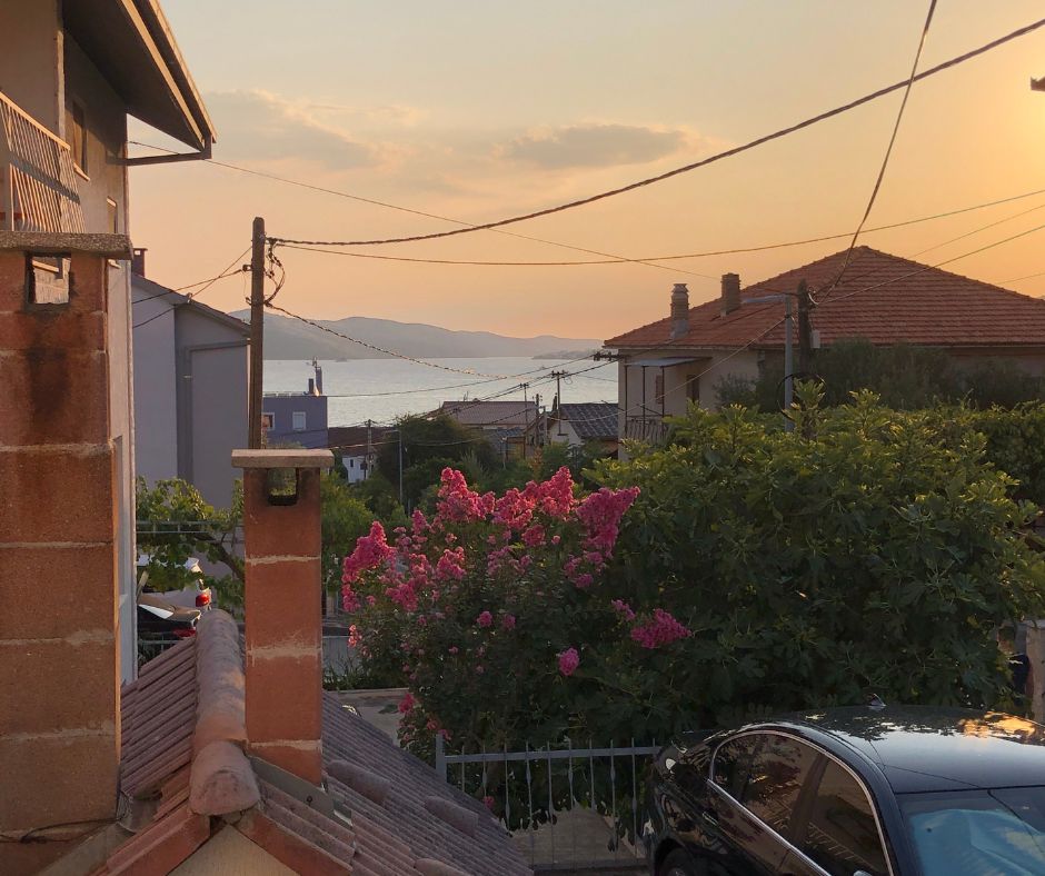 View from our bedroom window during sunset at the houses in front and the ocean