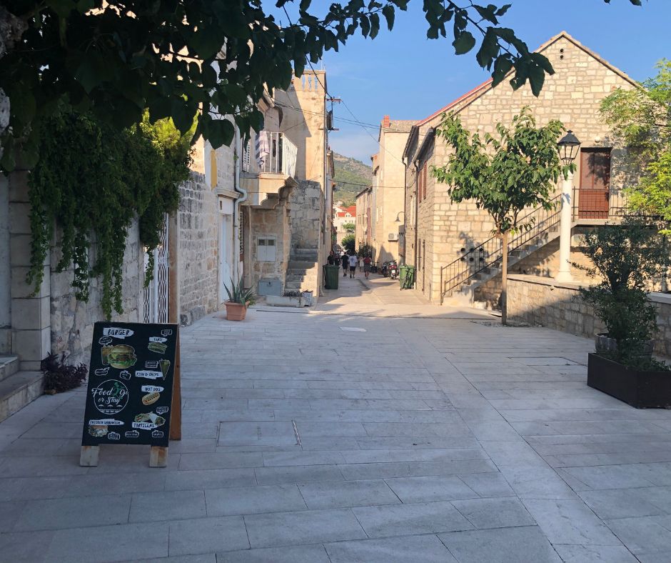 Looking down the narrow street of Bol. Old buildings line the side