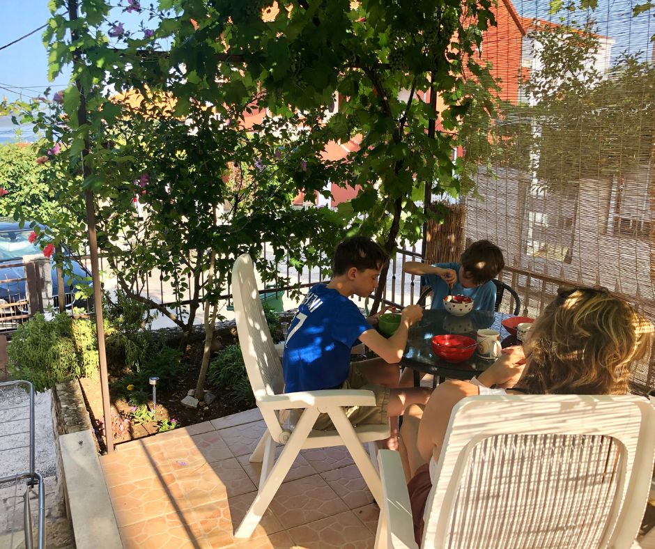 The family eating breakfast on the patio