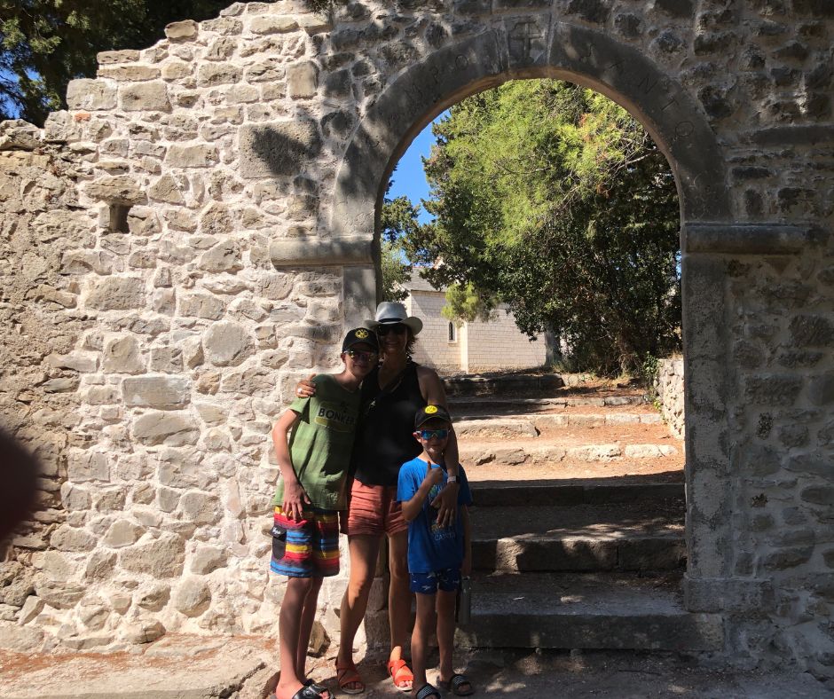 Connie and the boys posing at the arch entrance to the Church of St. Peter