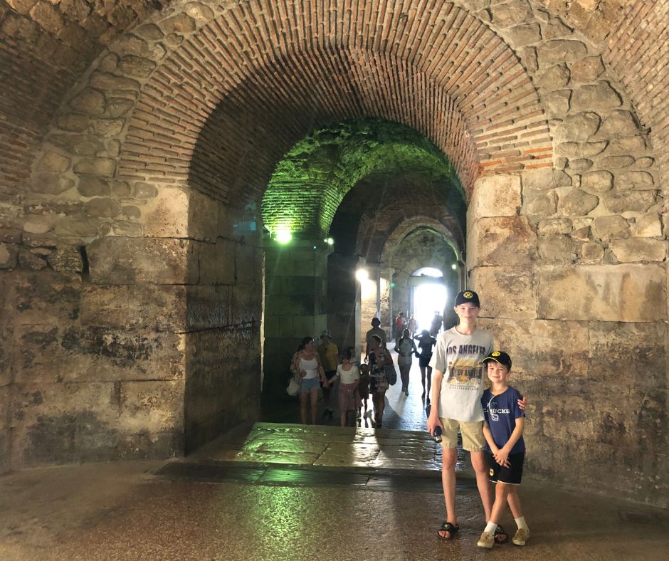 The boys inside Diocletian's Cellars walkways is definitely one of the things to do in Split