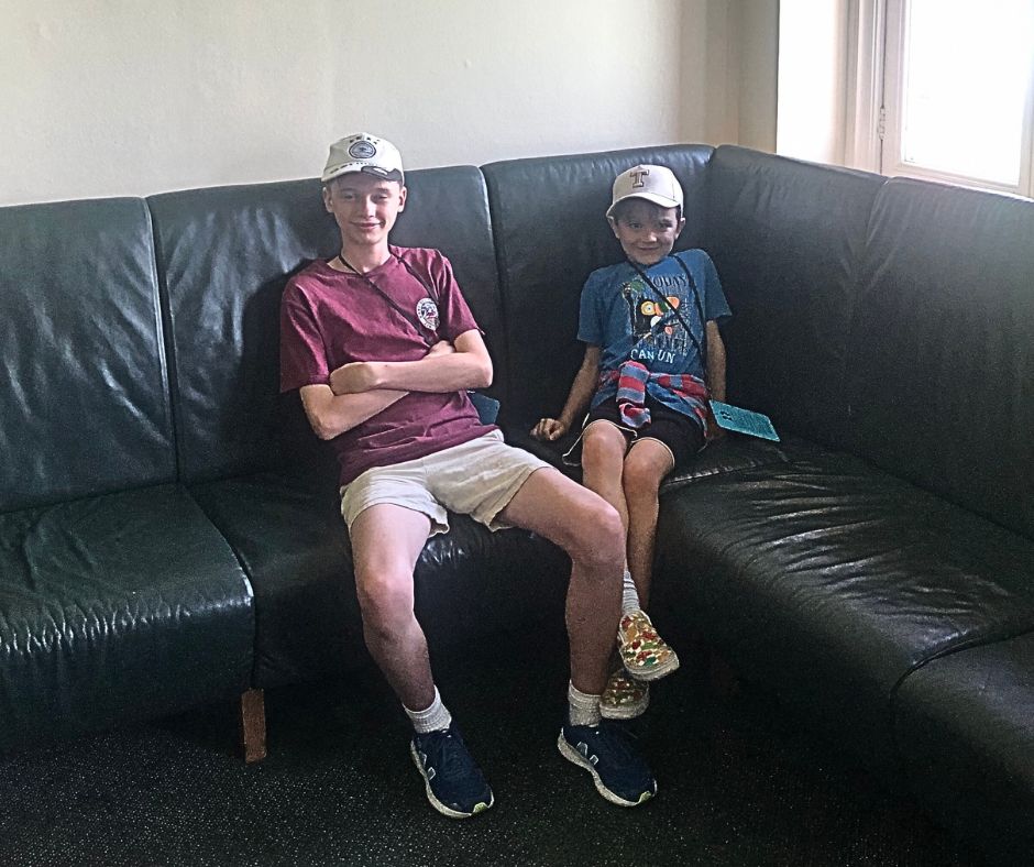 Sawyer and Lukas sitting in the visitors dressing room during the Lords Cricket Ground Tour