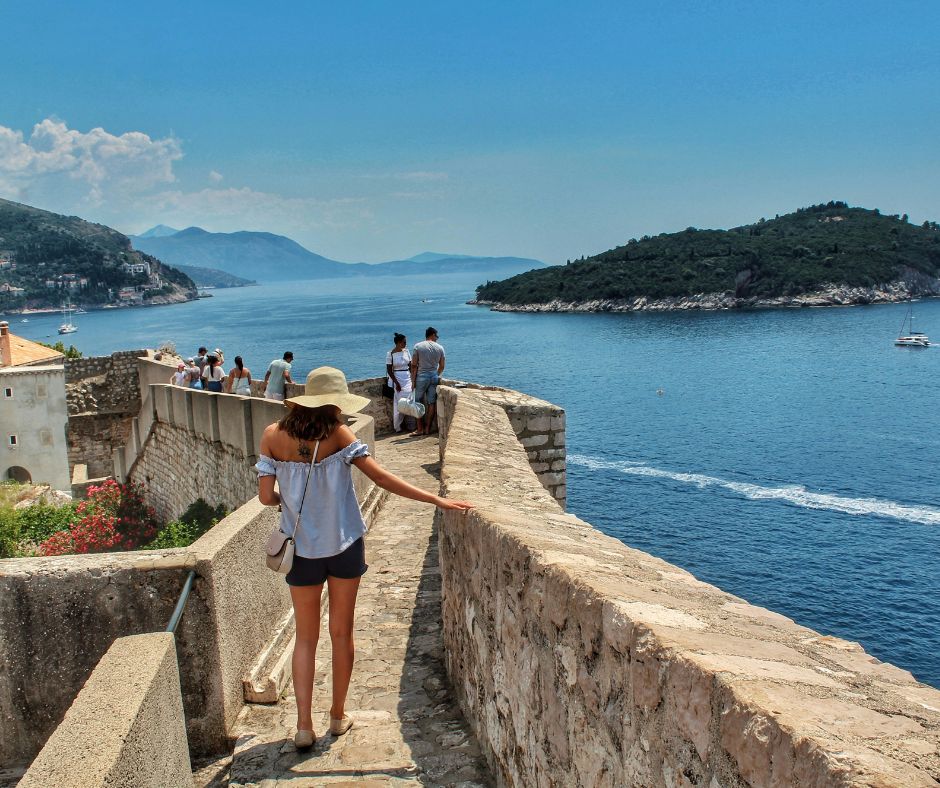 Walking around Dubrovnik's Old Town Walls with the island of Otok Lokrum and the coast in the background