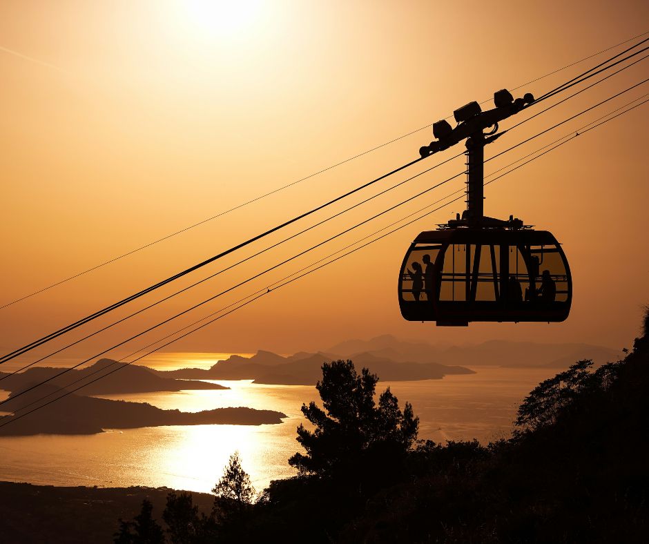 The Dubrovnik Cable Car above the mountain at sunset with the islands in the background. One of the top things to do in Dubrovnik