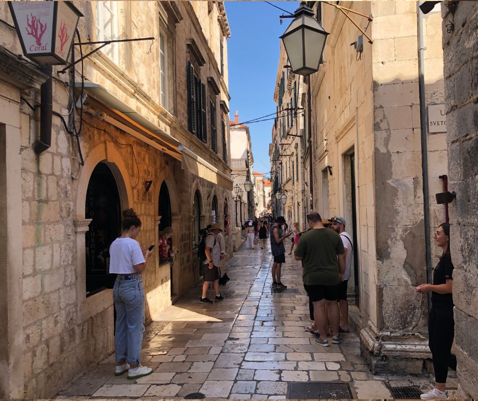 Looking down a narrow street in th Old Town, one of the free things to do in Dubrovnik. Lined by beautiful old buildings