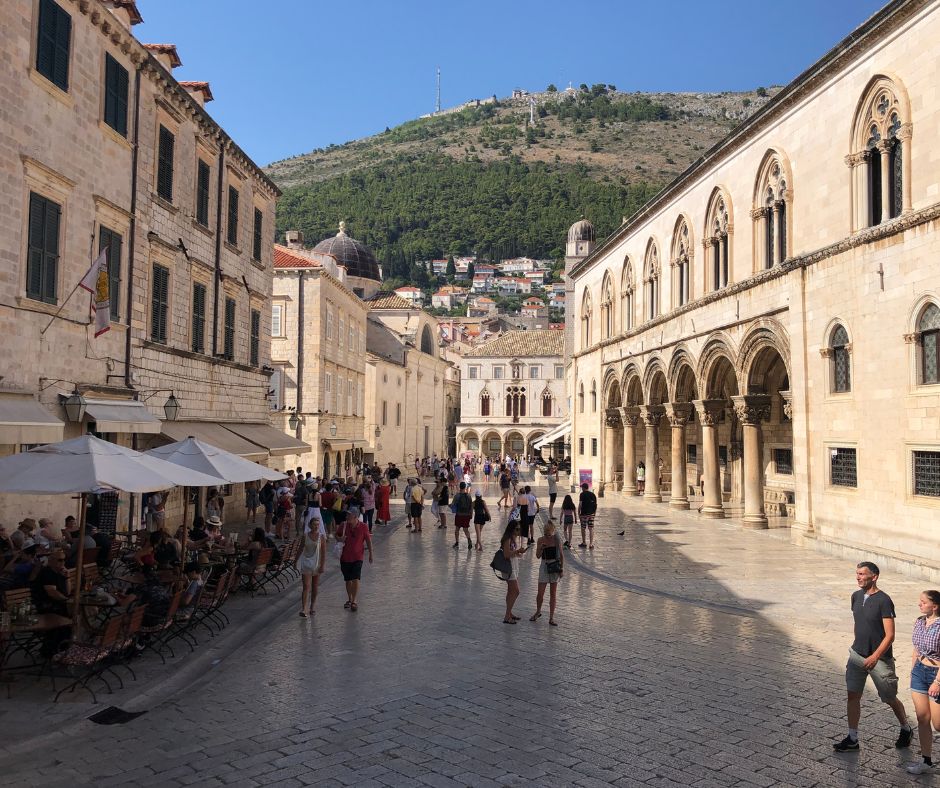 Looking down one of the wider streets in the Old Town with the mountains in the background