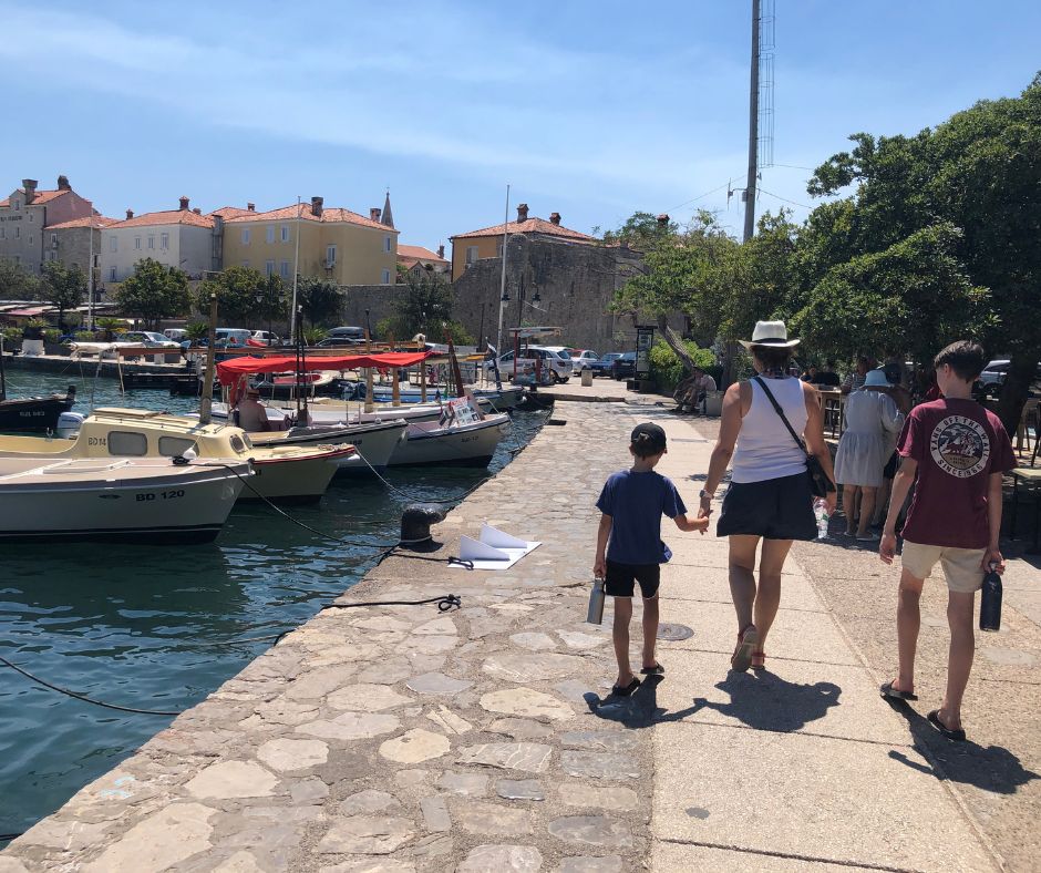 The boys and Connie walking along the promenade towards Budva's Old Town