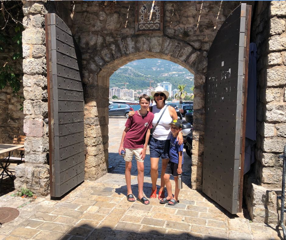 Connie and the boys standing in the Archway of the Old Town Gates