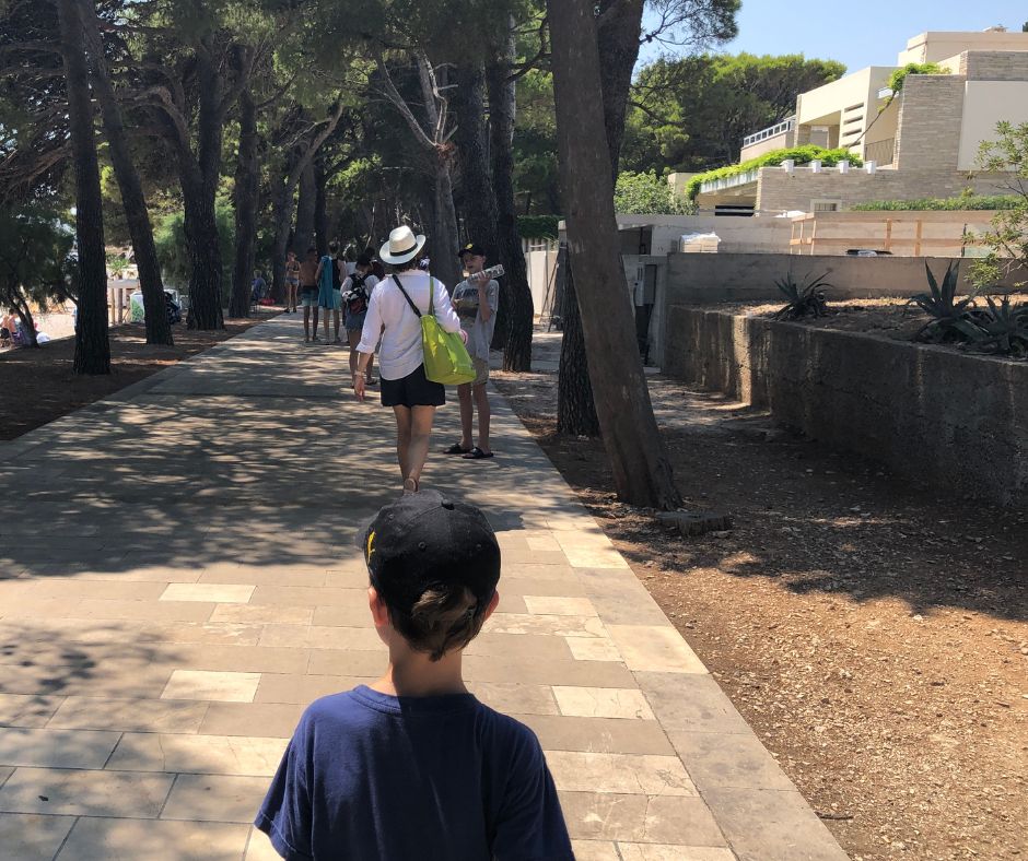 The family walking along the pine lined promenade