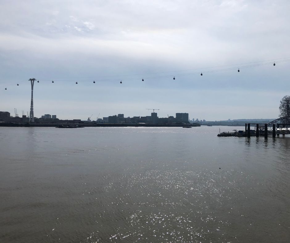 Looking back across the Thames river at the cable cars which are in the distance