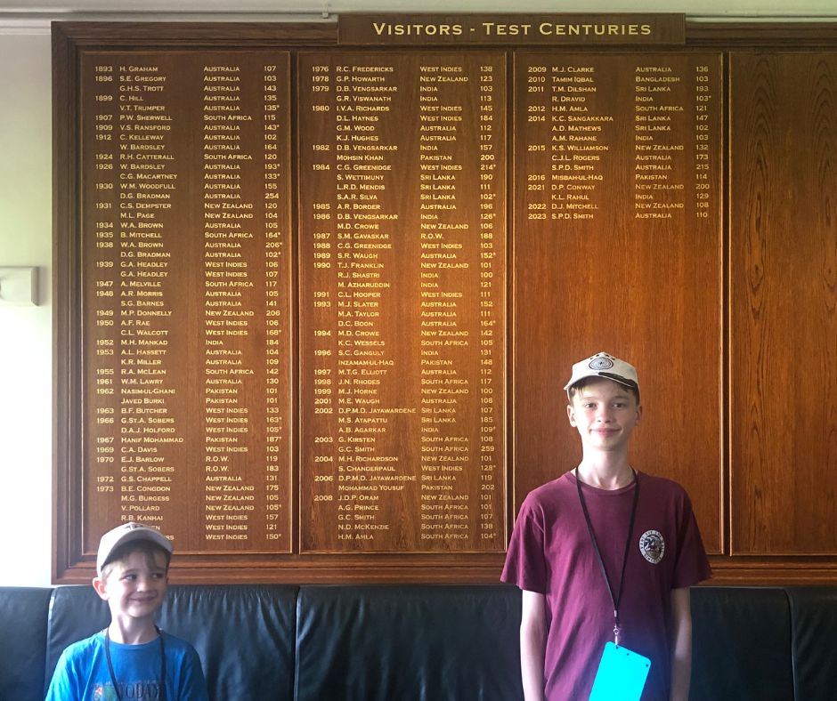 The boys stand in front on the visitor honours board during the Lords Cricket Ground Tour