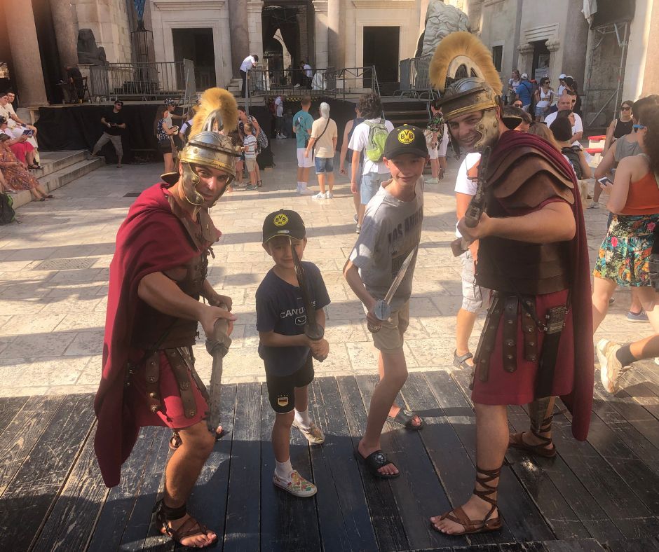 Boys posing with 2 dressed up gladiators, this is not one of the things to do in Split. It's a ripoff