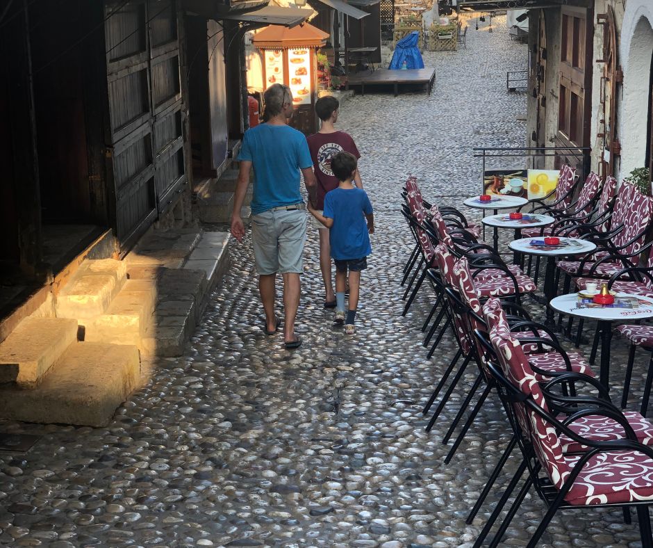 The boys walking through the Old Town on the cobble streets first thing in the morning