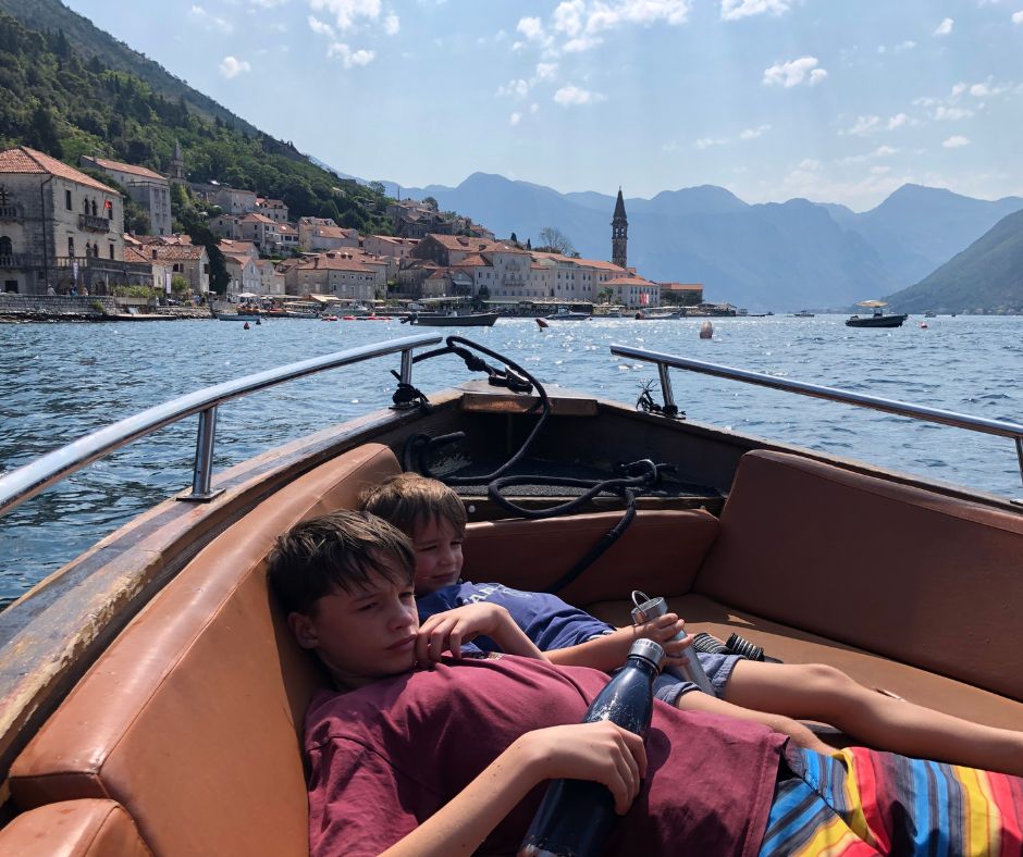 Boys laying down and relaxing as we cruise back to Perast