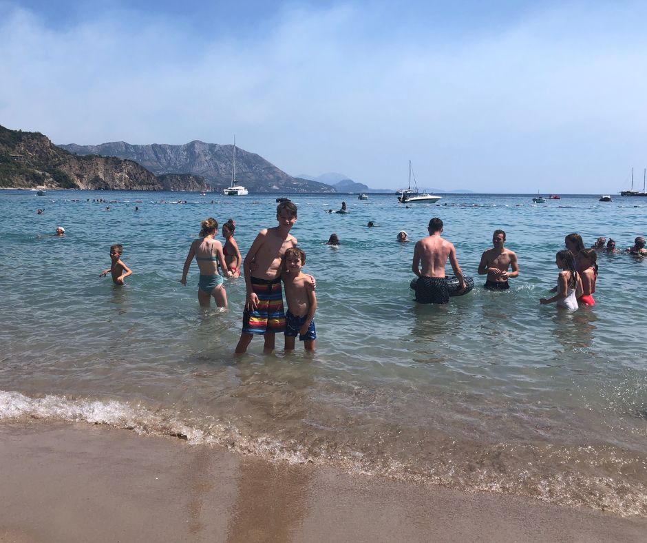 boys posing for a photo in the water