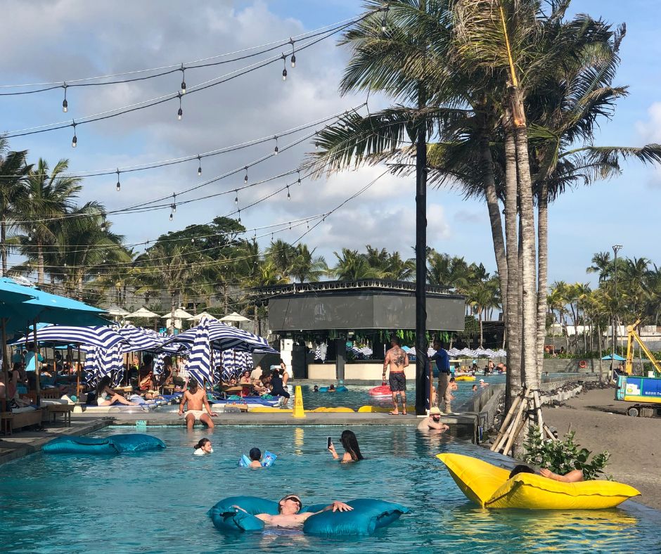 Looking across the infinity pool at people relaxing on inflatables