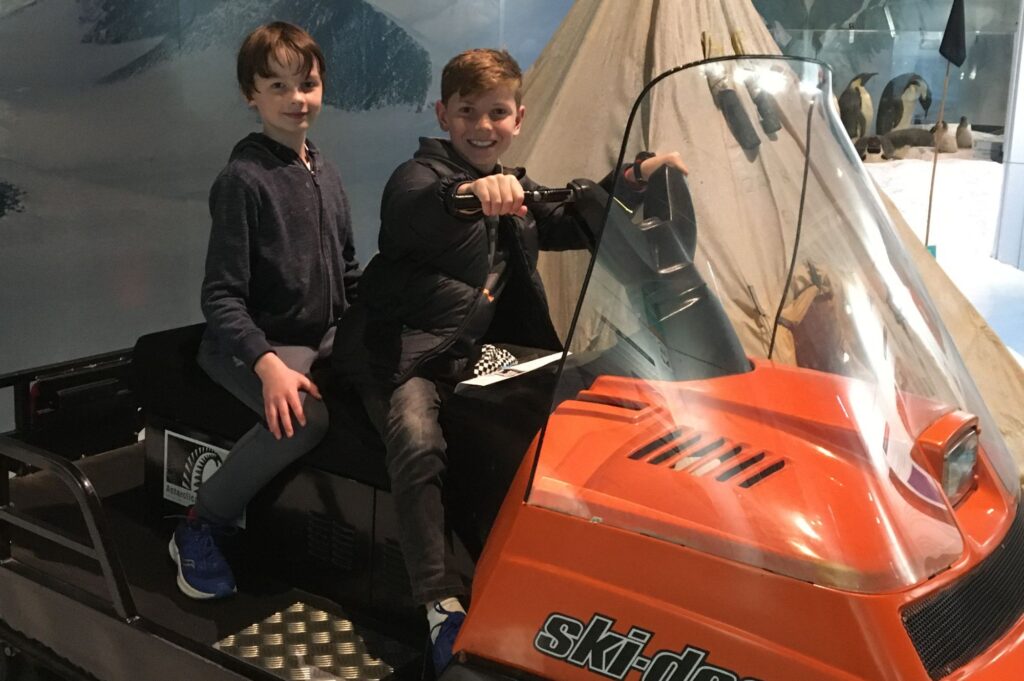 Luaks and a friend sitting on a ski-doo