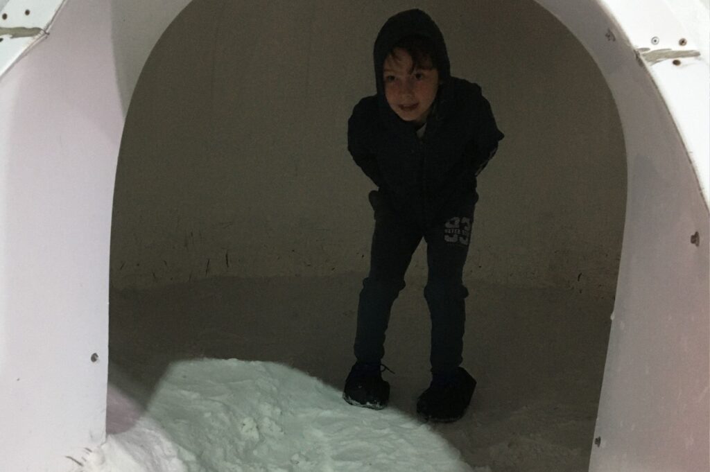 Lukas inside an igloo... little cold