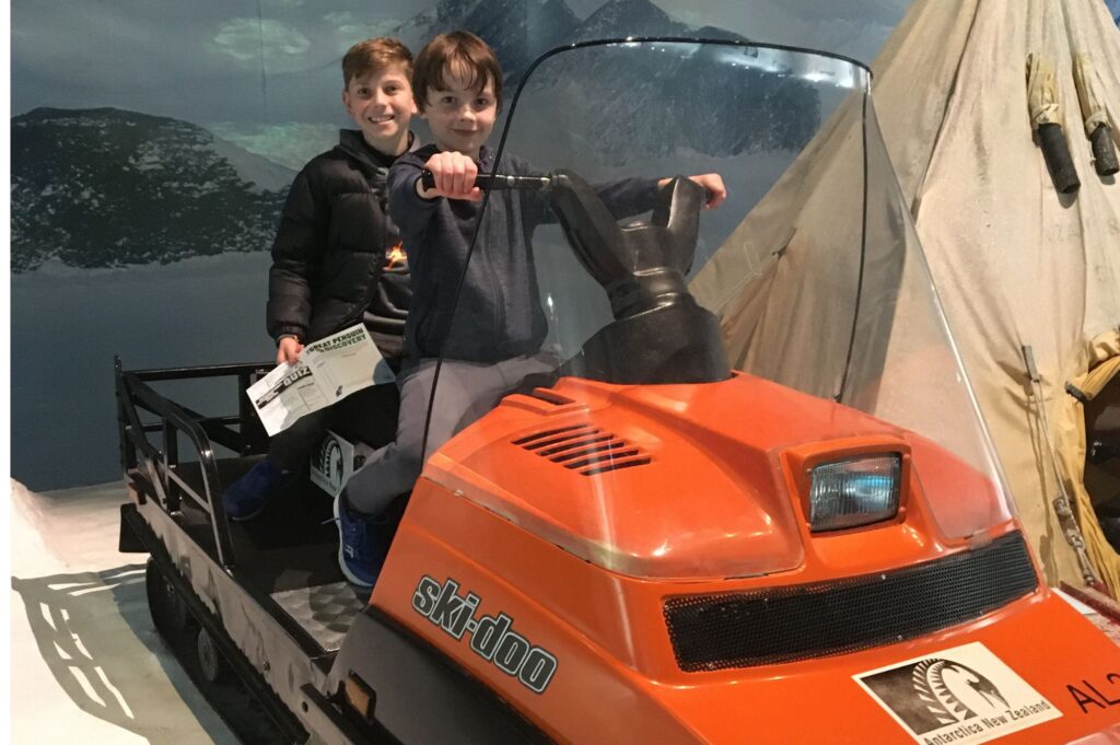 Lukas and a friend sitting of the ski-doo