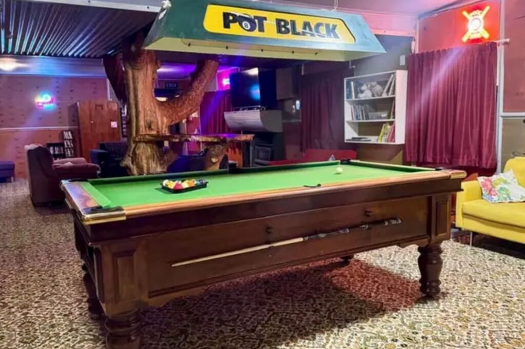 The Crossing Lodge shared space with pool table and sofas