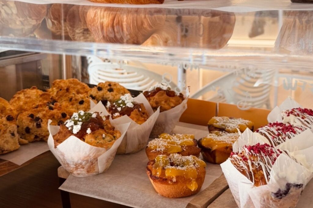 Looking at the cabinet food of muffins, rolls and breads
